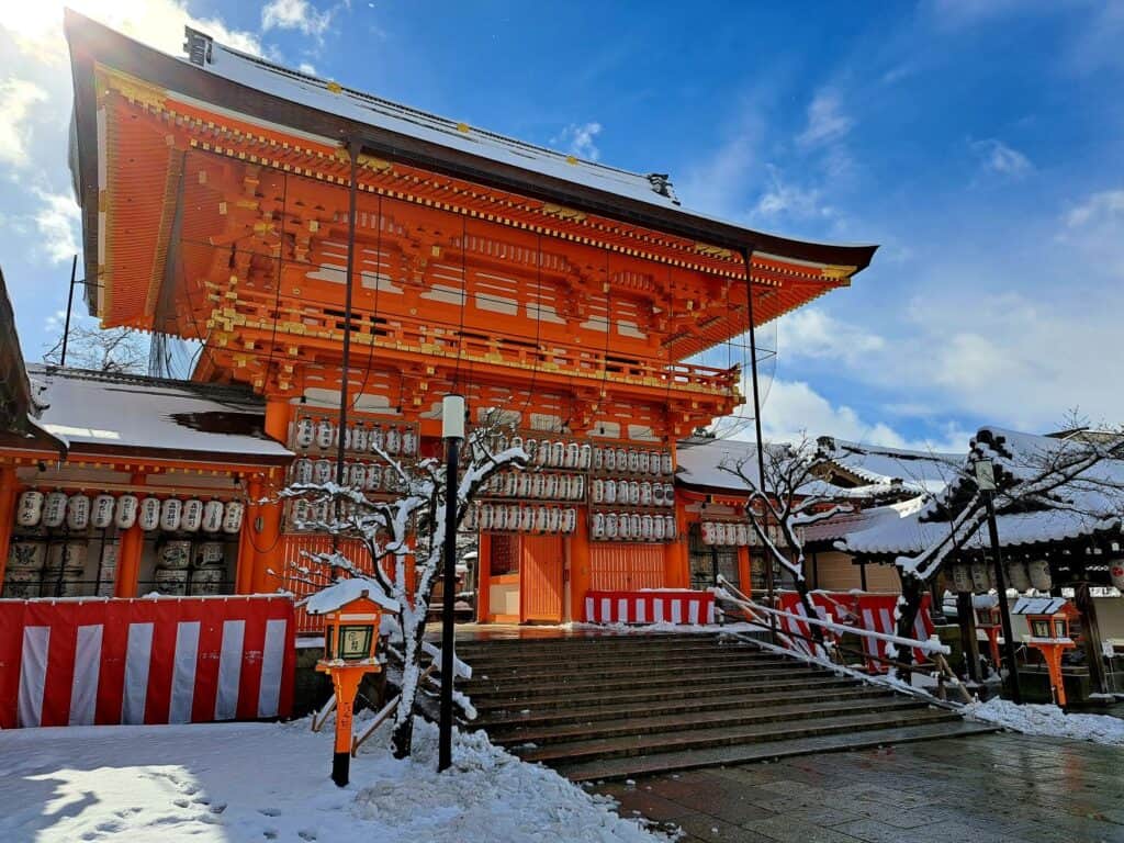 Large red temple building with protruding roof of Yasaka shrine, Kyoto