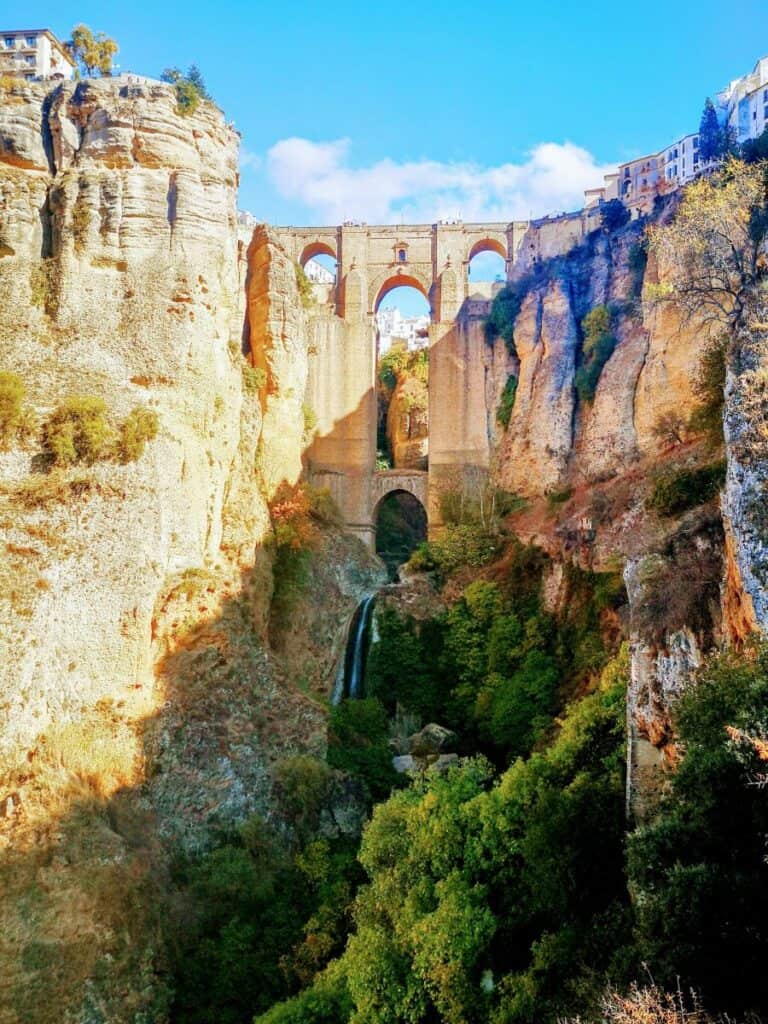 A 18th century stone arched bridge spans a 120m deep canyon in Ronda, Spain