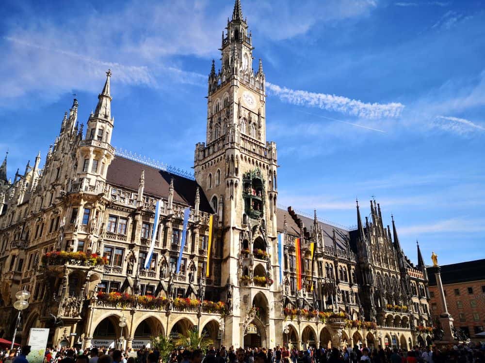 A large neo-Gothic town hall with a central tower in Munich's market square