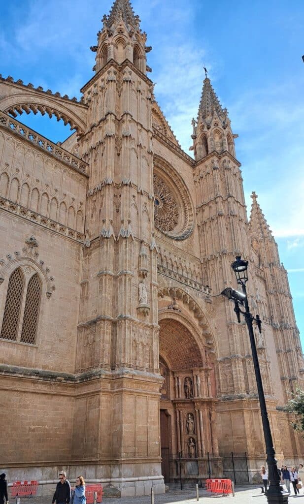 Two columns with turrets frame the large arched entrance to Palma Cathedral